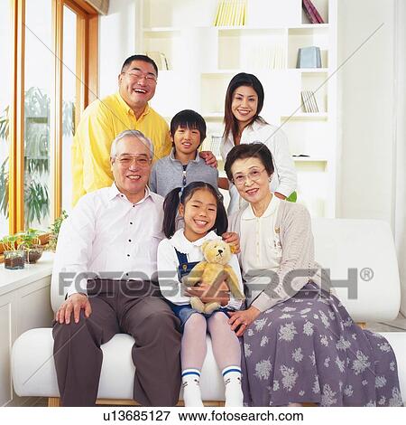 Portrait of Japanese family, Smiling, Looking at Camera, the Girl holding a teddy bear, Front View View Large Photo Image Stock Photo - Portrait of Japanese family, Smiling, Looking at Camera, the Girl holding a teddy bear, Front View. Fotosearch