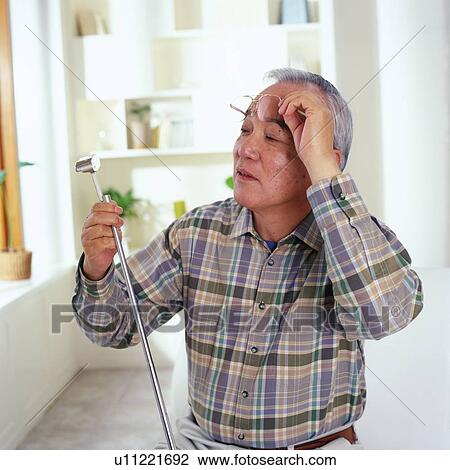 Senior man looking at his golf club, holding up glasses to his forehead, Side View View Large Photo Image Stock Image - Senior man looking at his golf club, holding up glasses to his forehead, Side View. Fotosearch