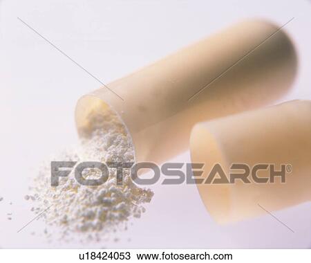Stock Image - Broken capsule with contents spilling out . Fotosearch