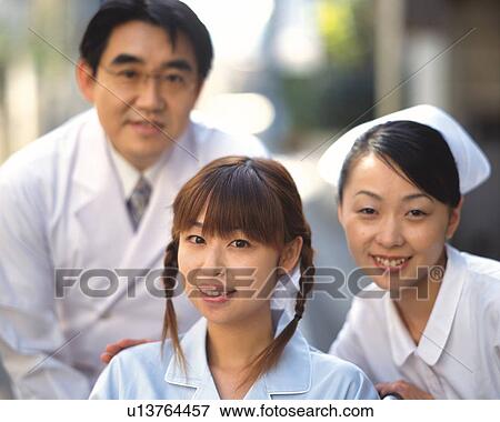 Stock Photo - Doctor and nurse and patient. Fotosearch