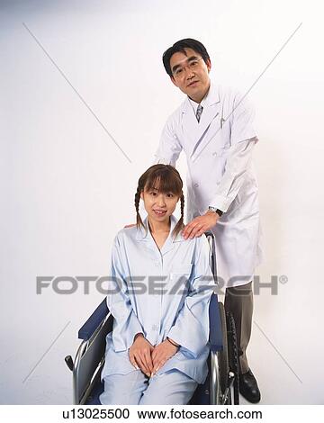 Stock Image - Doctor and patient in wheelchair . Fotosearch