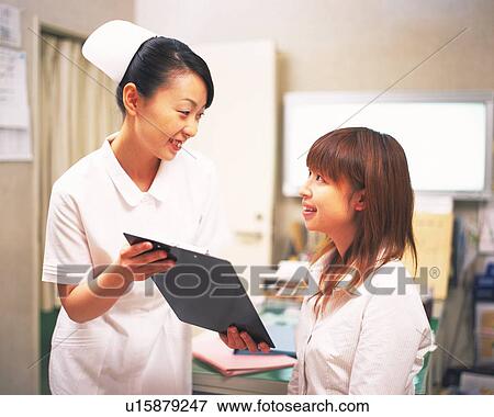 Stock Photo - Nurse examining patient. Fotosearch