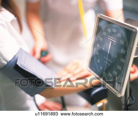 Nurse taking male patient's blood pressure View Large Photo Image Stock Image - Nurse taking male patient's blood pressure . Fotosearch