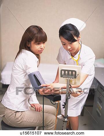 Stock Photo - Nurse taking male patient's blood pressure . Fotosearch
