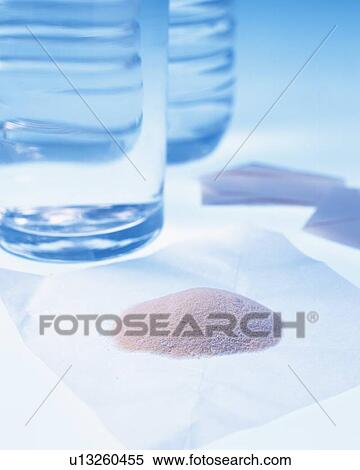 Stock Photography - Powder on the medicinal wafer and water. Fotosearch