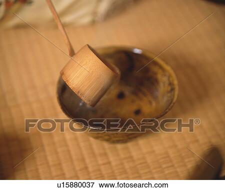 Stock Photo - Bamboo dipper scooping hot water from tea cup for tea ceremony, high angle view, Japan, differential focus. Fotosearch