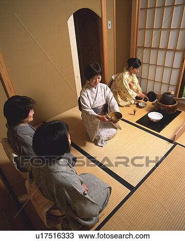 Stock Image - Four women attending Japanese tea ceremony, high angle view, Japan. Fotosearch