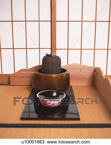 Stock Image - Japanese tea set on Tatami mat, high angle view, Japan. Fotosearch