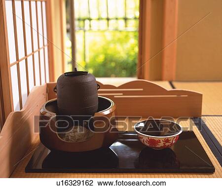 Stock Image - Japanese tea set on Tatami mat, high angle view, Japan, differential focus. Fotosearch