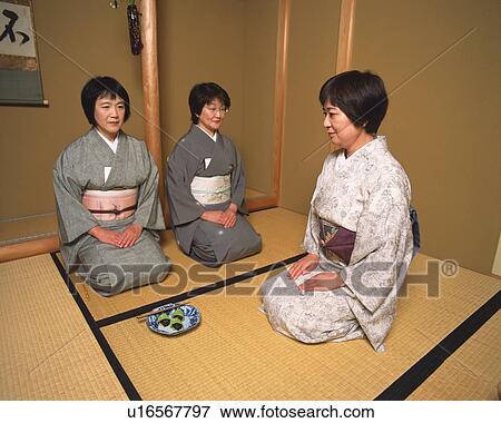 Stock Photo - Three women sitting on Tatami mat in a tea room, front view, side view, Japan. Fotosearch