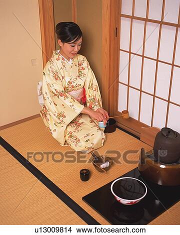 Woman in kimono holding a bamboo dipper in a tea room, high angle view, Japan View Large Photo Image Picture - Woman in kimono holding a bamboo dipper in a tea room, high angle view, Japan. Fotosearch