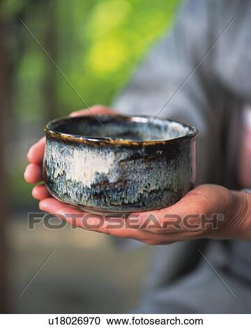 Woman in kimono holding a tea cup at tea ceremony, side view, close up, Japan, differential focus View Large Photo Image Stock Image - Woman in kimono holding a tea cup at tea ceremony, side view, close up, Japan, differential focus. Fotosearch