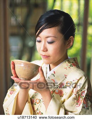Woman in kimono holding a tea cup at tea ceremony, front view, Japan, differential focus View Large Photo Image Stock Image - Woman in kimono holding a tea cup at tea ceremony, front view, Japan, differential focus. Fotosearch