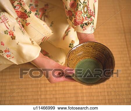 Woman in kimono holding a tea cup at tea ceremony, high angle view, Japan, differential focus View Large Photo Image Stock Photo - Woman in kimono holding a tea cup at tea ceremony, high angle view, Japan, differential focus. Fotosearch