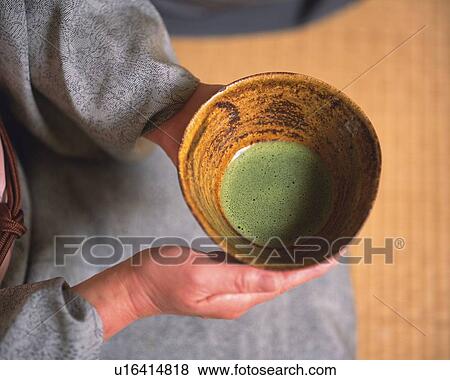 Stock Photo - Woman in kimono holding a tea cup at tea ceremony, high angle view, close up, Japan, differential focus. Fotosearch