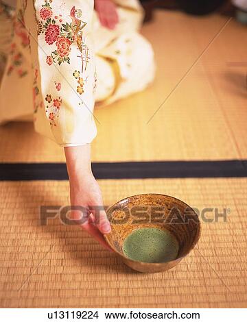 Woman in kimono serving a cup of green tea at tea ceremony, high angle view, Japan, differential focus View Large Photo Image Picture - Woman in kimono serving a cup of green tea at tea ceremony, high angle view, Japan, differential focus. Fotosearch