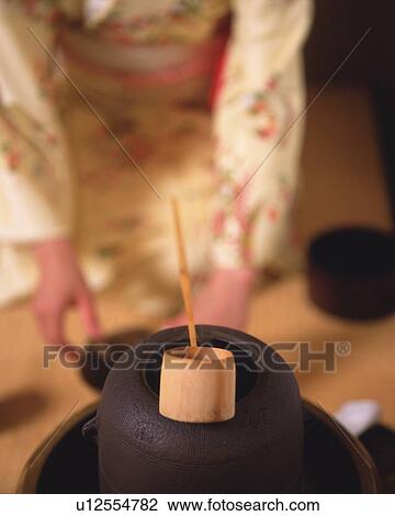 Woman in kimono setting up for tea ceremony, front view, Japan, differential focus View Large Photo Image Stock Image - Woman in kimono setting up for tea ceremony, front view, Japan, differential focus. Fotosearch