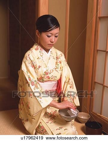Woman in kimono sitting and cleaning a cup in a tea room, front view, Japan View Large Photo Image Stock Photo - Woman in kimono sitting and cleaning a cup in a tea room, front view, Japan. Fotosearch