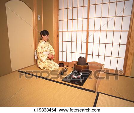 Picture - Woman in kimono sitting in a tea room, side view, Japan. Fotosearch