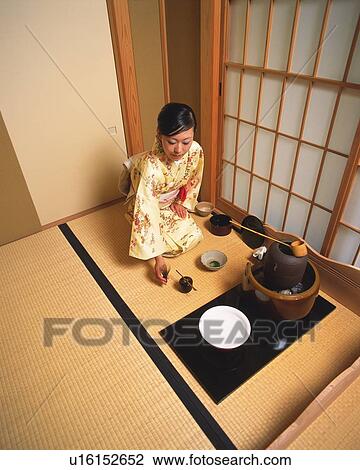 Stock Image - Woman in kimono sitting in a tea room, high angle view, Japan. Fotosearch