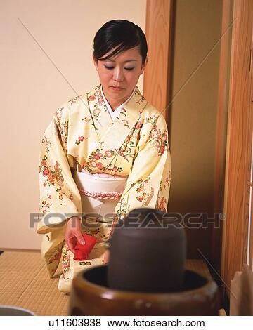 Stock Photo - Woman in kimono sitting in a tea room, front view, Japan, differential focus. Fotosearch