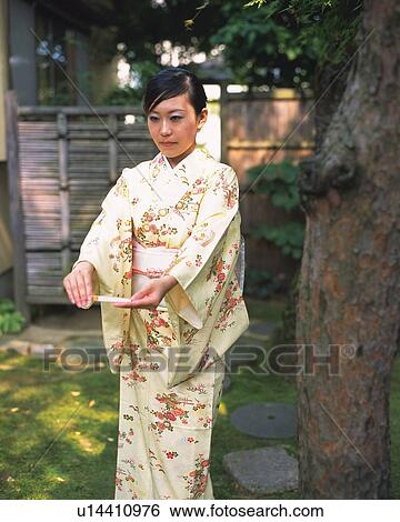 Woman in kimono standing in Japanese garden, front view, Japan, differential focus View Large Photo Image Stock Photograph - Woman in kimono standing in Japanese garden, front view, Japan, differential focus. Fotosearch