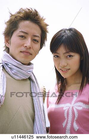 Young couple smiling, portrait View Large Photo Image Stock Photography - Young couple smiling, portrait . Fotosearch