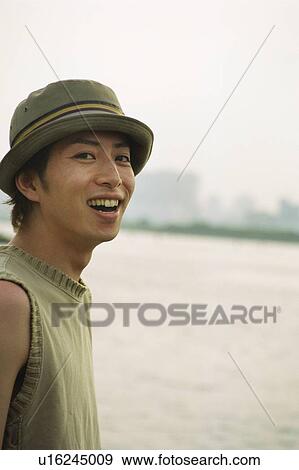Stock Photo - Young man smiling, portrait . Fotosearch
