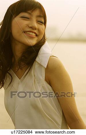 Young woman looking back, portrait View Large Photo Image Picture - Young woman looking back, portrait. Fotosearch
