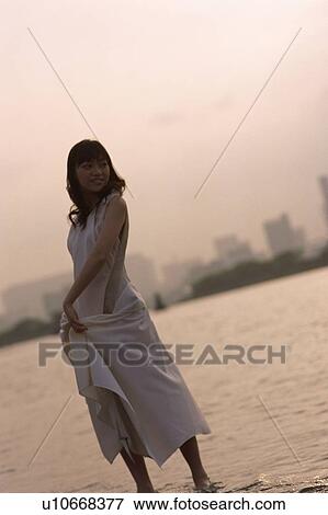 Stock Photo - Young woman looking back, portrait. Fotosearch
