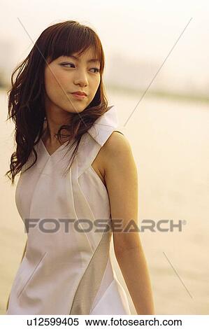 Young woman looking back, portrait View Large Photo Image Stock Photography - Young woman looking back, portrait. Fotosearch