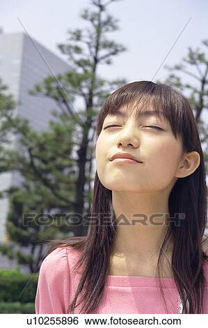 Young woman looking up the sky, closed eyes View Large Photo Image Stock Photograph - Young woman looking up the sky, closed eyes. Fotosearch