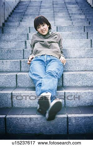 Young woman lying on the stairs, portrait View Large Photo Image Stock Photo - Young woman lying on the stairs, portrait . Fotosearch