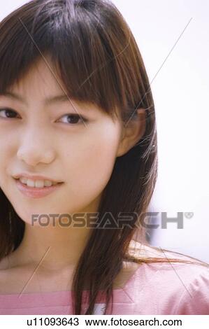Young woman smiling, portrait View Large Photo Image Stock Image - Young woman smiling, portrait . Fotosearch