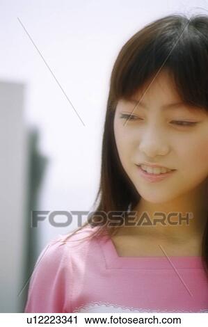 Stock Image - Young woman smiling, portrait . Fotosearch