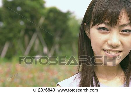 Young woman smiling, portrait View Large Photo Image Stock Image - Young woman smiling, portrait . Fotosearch