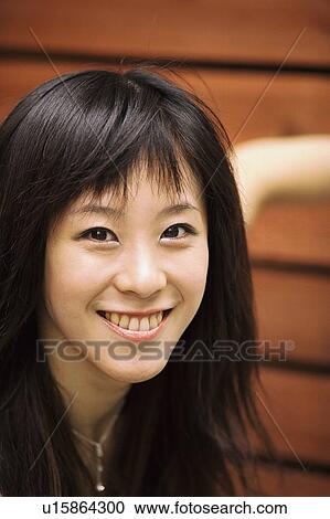 Stock Image - Young woman smiling, portrait . Fotosearch