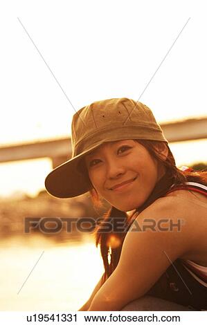 Stock Image - Young woman smiling, portrait . Fotosearch