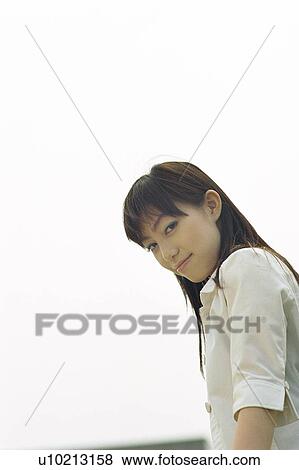 Stock Photo - Young woman smiling, portrait . Fotosearch