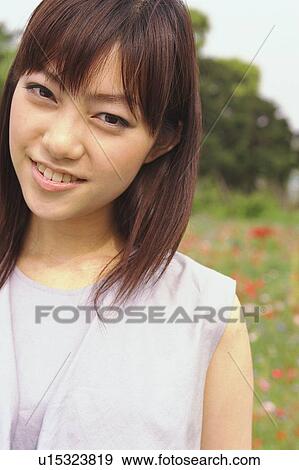Young woman smiling, portrait View Large Photo Image Stock Photo - Young woman smiling, portrait . Fotosearch