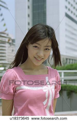 Young woman smiling, portrait View Large Photo Image Stock Photography - Young woman smiling, portrait . Fotosearch