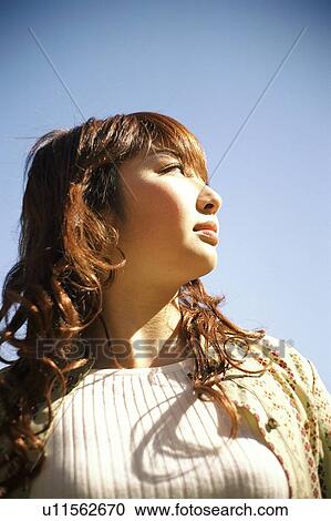 Young woman under the sky View Large Photo Image Stock Image - Young woman under the sky. Fotosearch
