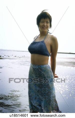 Young women standing at the water edge View Large Photo Image Stock Image - Young women standing at the water edge. Fotosearch