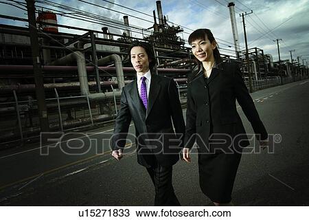 Stock Image - Business Man and Business Woman at the Factory. Fotosearch