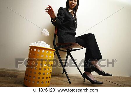 Stock Image - Business Woman and the Rubbish Bin. Fotosearch