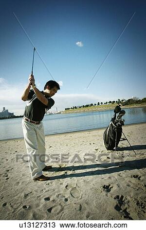 Stock Image - Mature Adult Man Playing Golf. Fotosearch