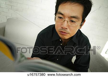 Stock Image - Mature Adult Man Reading a Book. Fotosearch