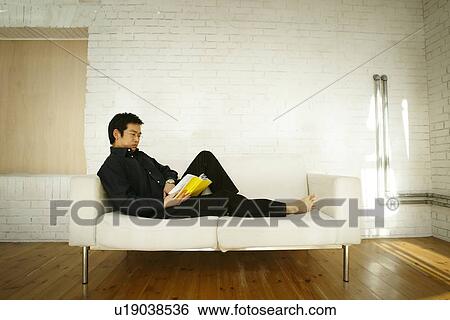 Stock Photograph - Mature Adult Man Reading a Book. Fotosearch