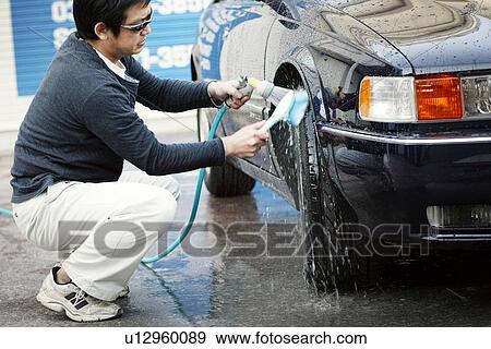 Stock Photo - Mature Adult Man Washing a Car. Fotosearch