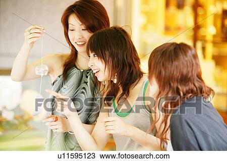 Stock Image - Three Young Adult Women shopping. Fotosearch